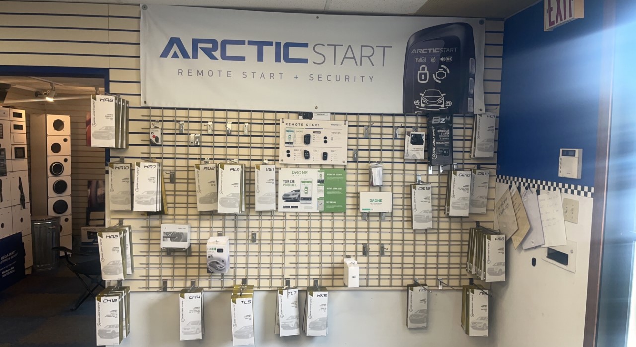 Wall of remote starters in the Mega Watt Car Security shop