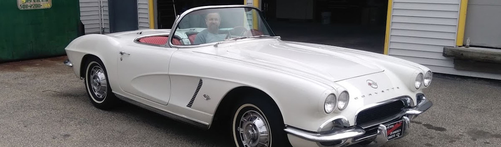 Man sitting in a white Corvette