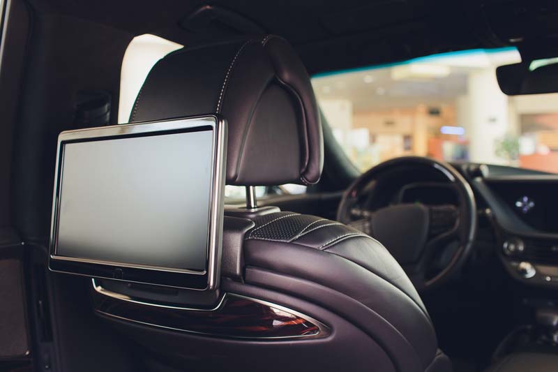 Video player behind the headrest of a car